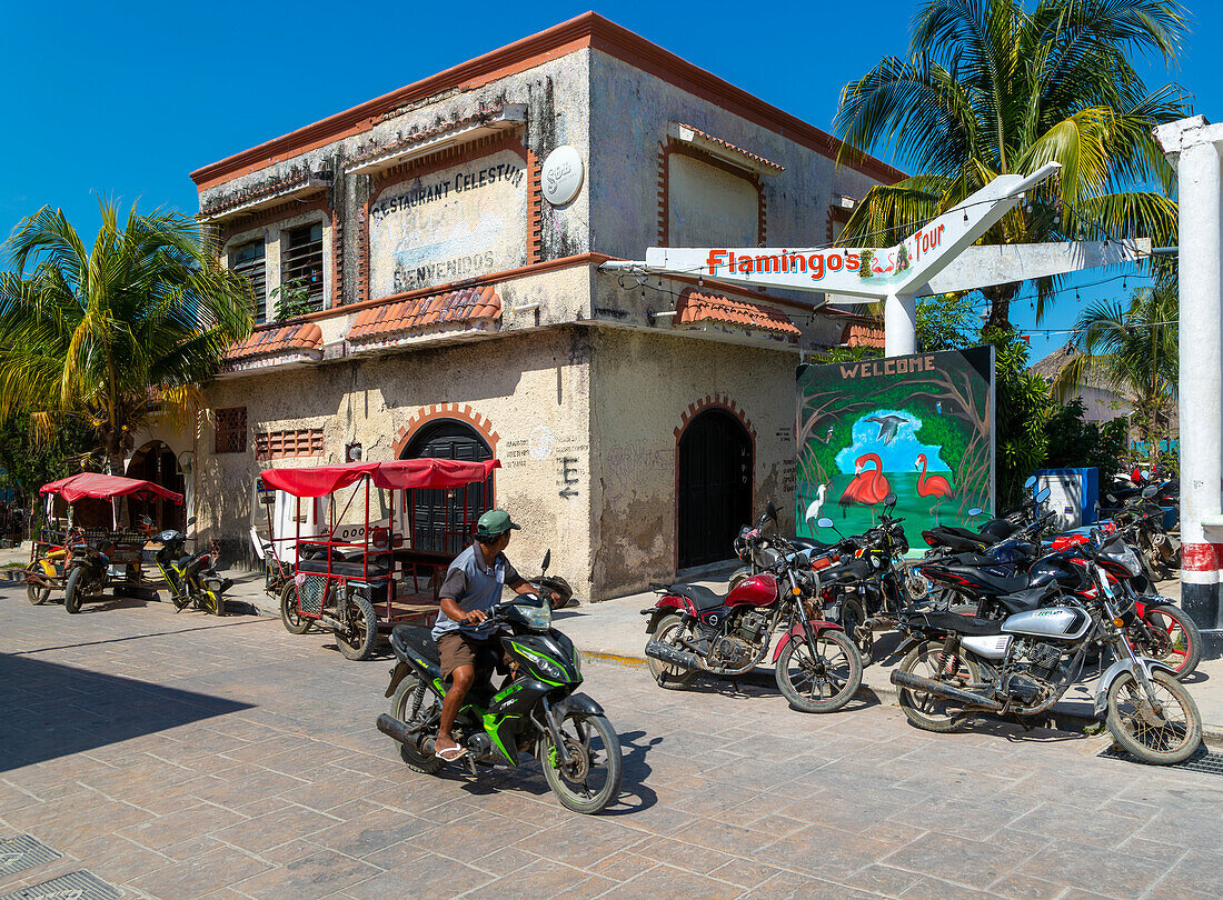 Street scene with motorcycle vehicles in centre of small settlement of Celestun, Yucatan, Mexico