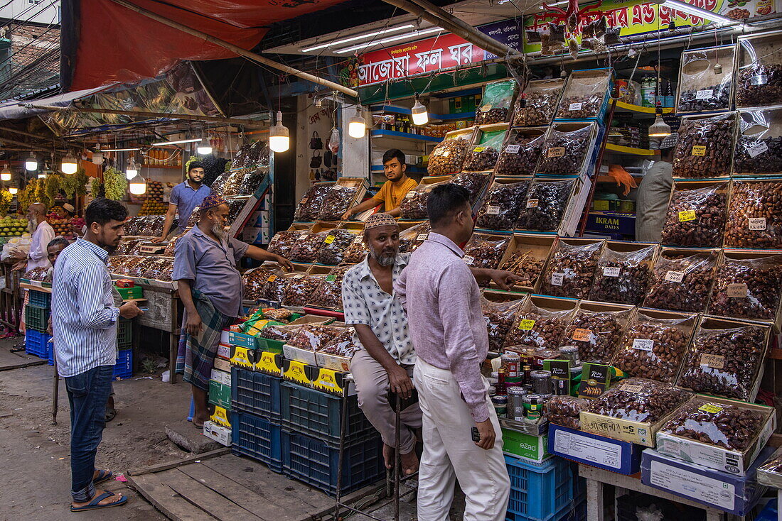  Men stand in front of a market stall selling dates, Barisal (Barishal), Barisal District, Bangladesh, Asia 