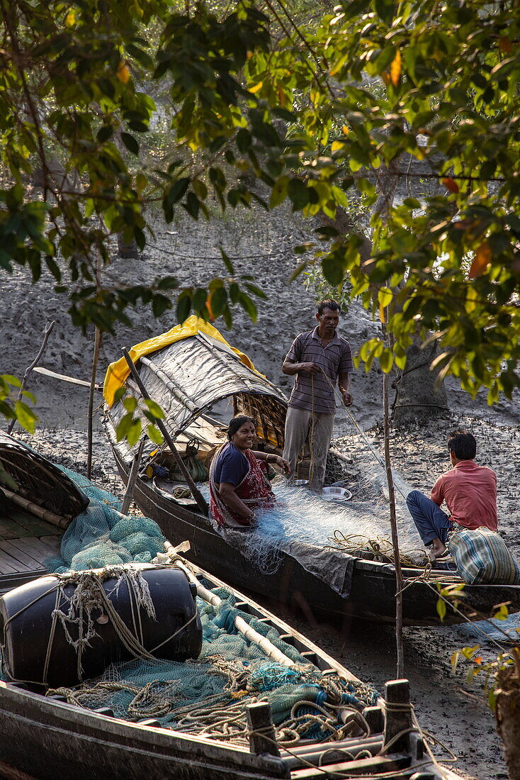  People repairing fishing nets on a boat, Pakhiralay, near Gosaba, South 24 Parganas District, West Bengal, India, Asia 