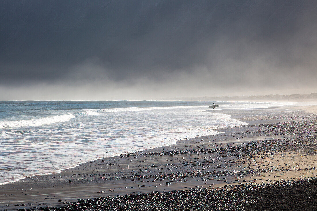 Atlantic Ocean coast beach and waves with morning sea mist, Caleta de Famara, Lanzarote, Canary islands, Spain