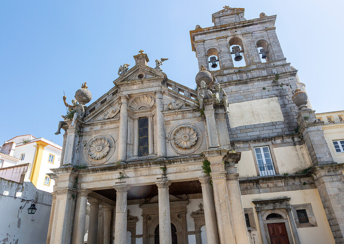 Sixteenth century church of Igreja de Nossa Senhora de Graca, Evora, Alto Alentejo, Portugal, southern Europe built in Italian Renaissance style facade having a portico with Tuscan columns architectural designs by Miguel de Arruda. Two stone Atlas-like figures sit on each corner nicknamed by locals the 'children of Grace'