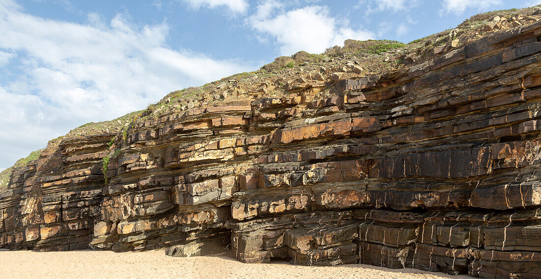 Tilted layers showing bedding planes in strata of sedimentary rock in coastal cliff at Odeceixe, Algarve, Portugal, Southern Europe, Southwest Alentejo and Vicentina Coast Natural Park