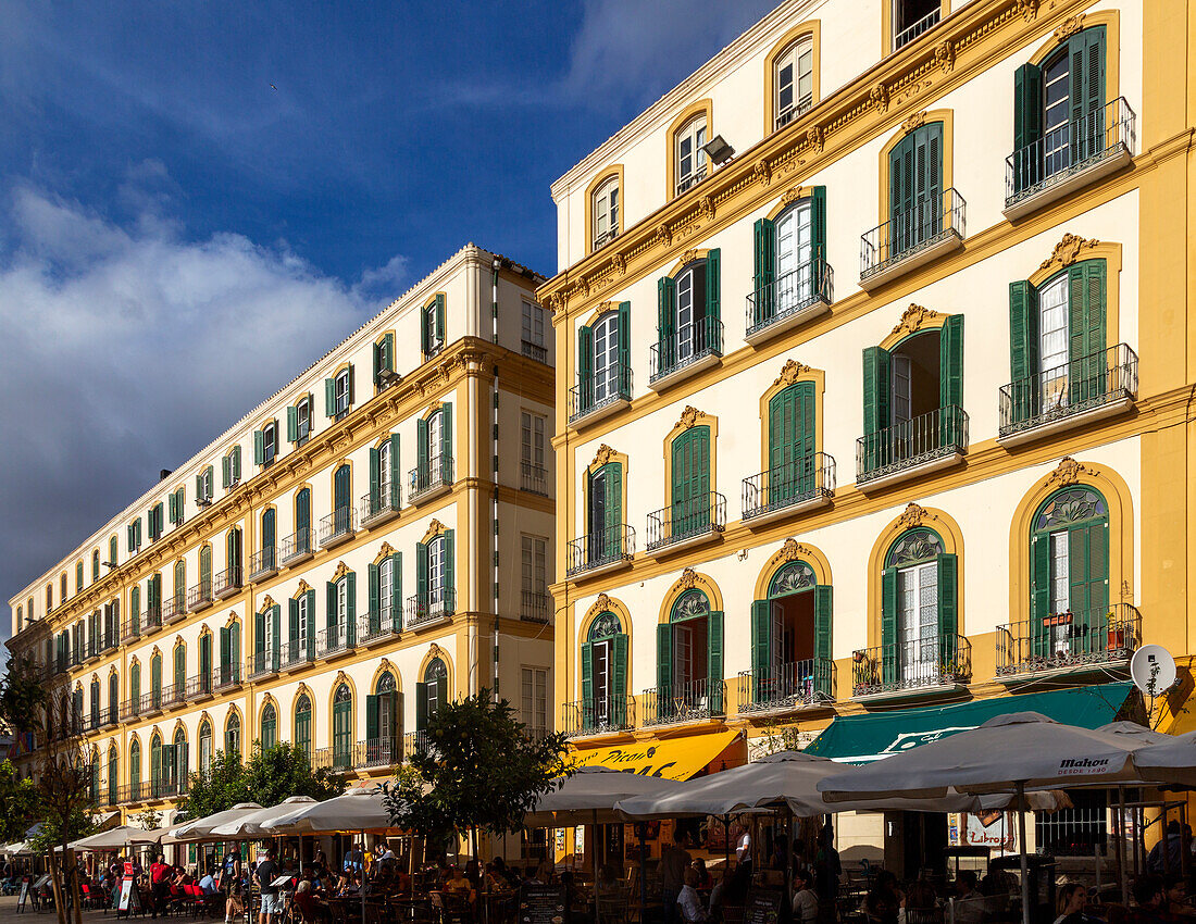 Winter evening sunshine historic facade of buildings, Plaza de la Merced, Malaga, Andalusia, Spain