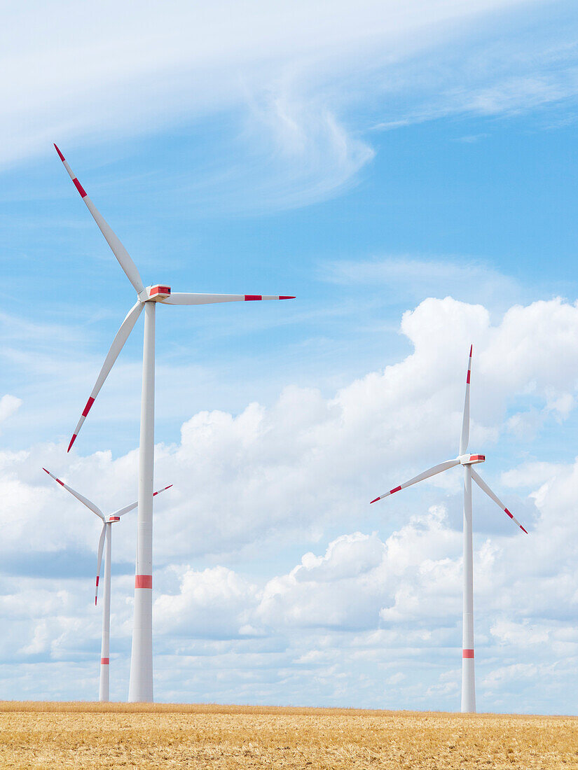  Wind turbines against a blue cloudy sky, Alzey, Rhineland-Palatinate, Germany 