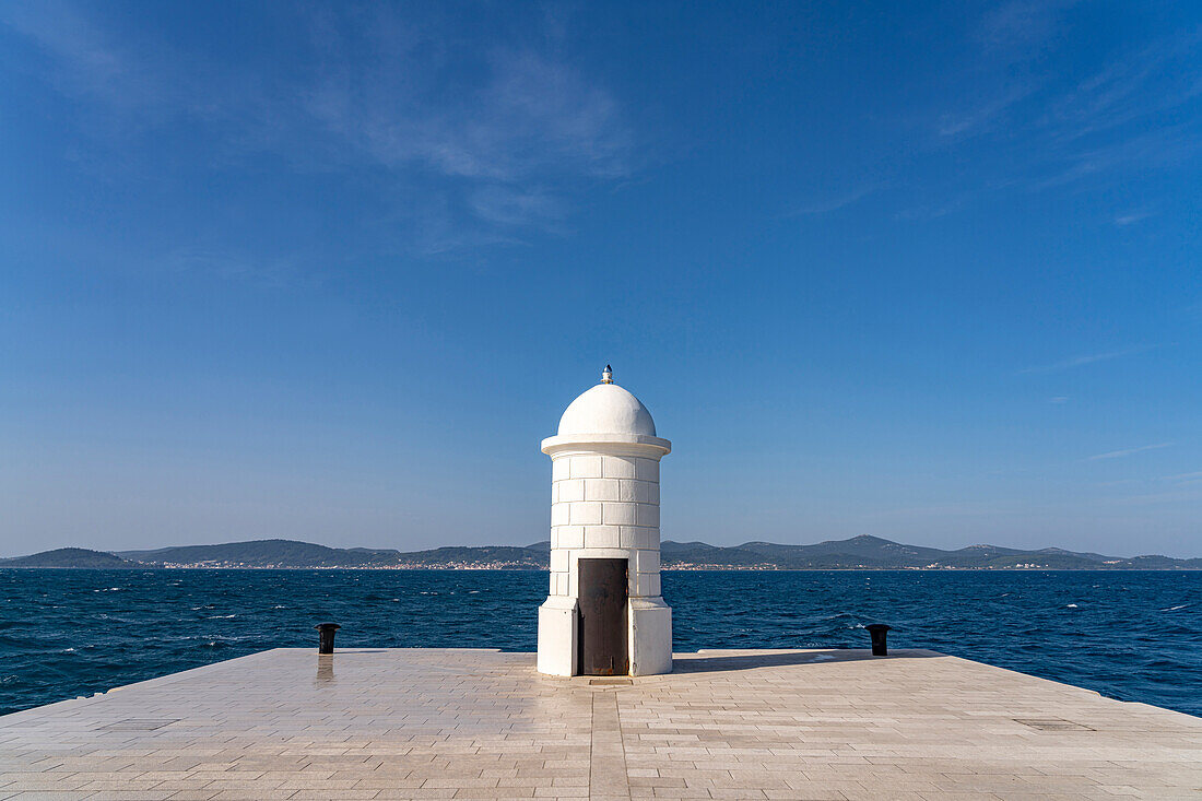  Small white lighthouse on the pier in Zadar, Croatia, Europe 