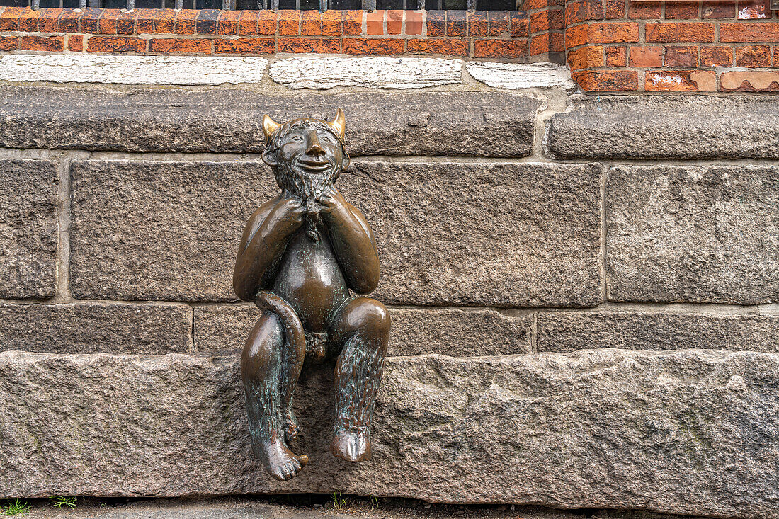  Little devil bronze sculpture at St. Mary&#39;s Church, Hanseatic City of Lübeck, Schleswig-Holstein, Germany  