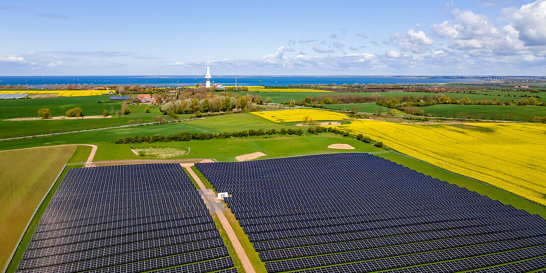  View of a PV area with the Baltic Sea in the background, Ostholstein, Schleswig-Holstein, Germany 