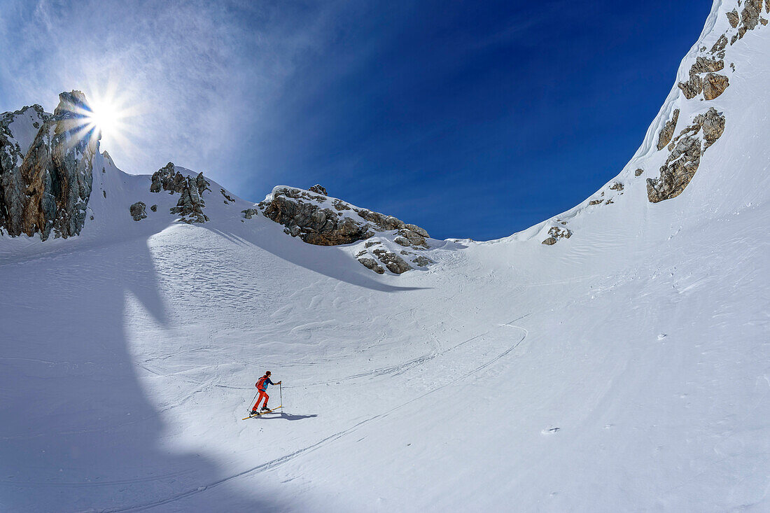  Woman on ski tour ascending the Forcella di Sasse, Civetta Group, Dolomites, UNESCO World Heritage Dolomites, Veneto, Italy 