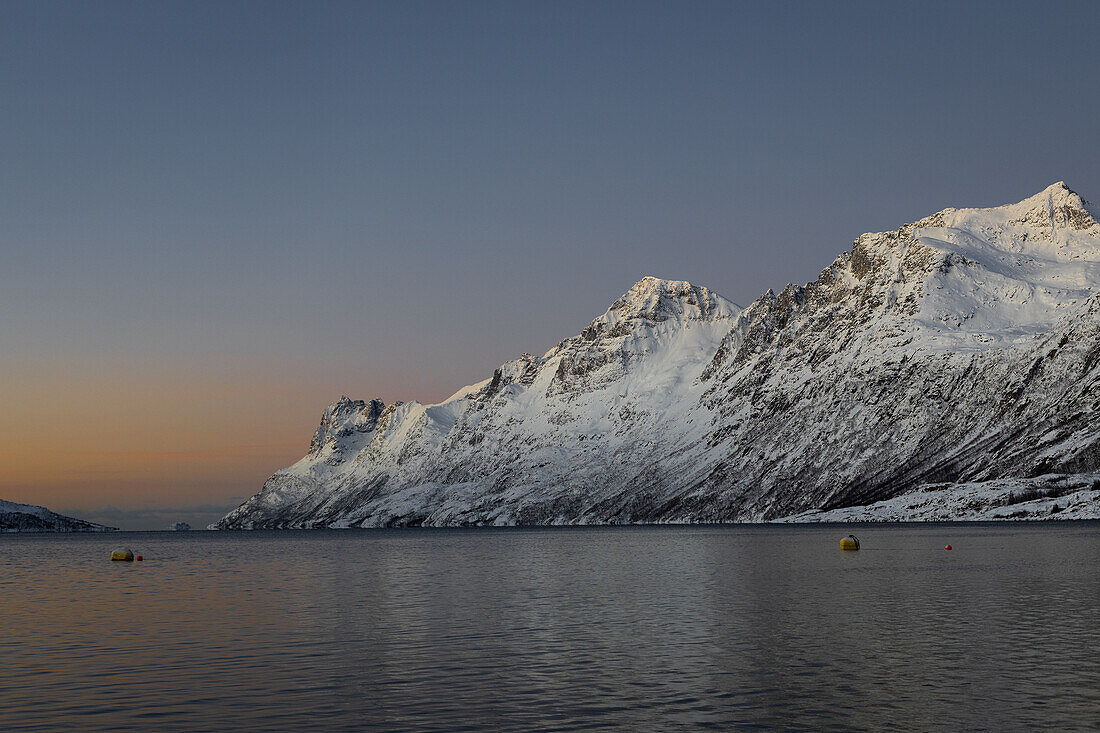  Winter in the Trömso region, Ersfjordbotn with mountains in the twilight 