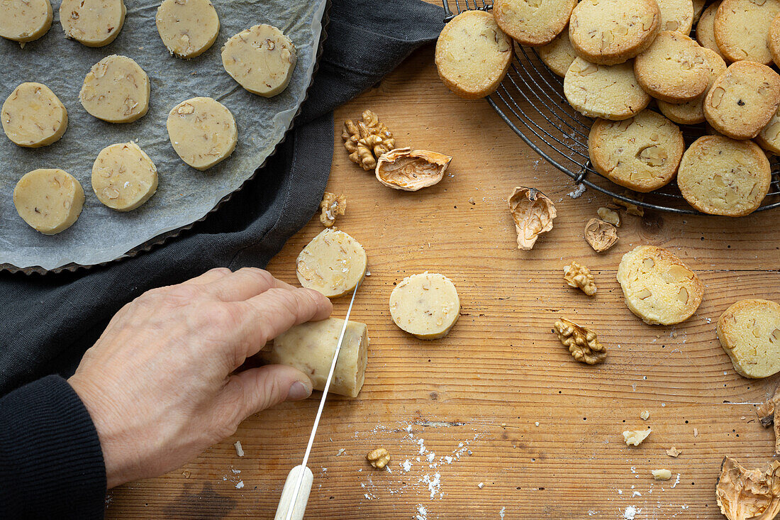  Sablés with walnuts, on tray, rack and wooden board, baked and unbaked. 