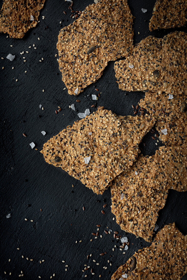  Crispbread with seeds, sesame and salt on a dark background  