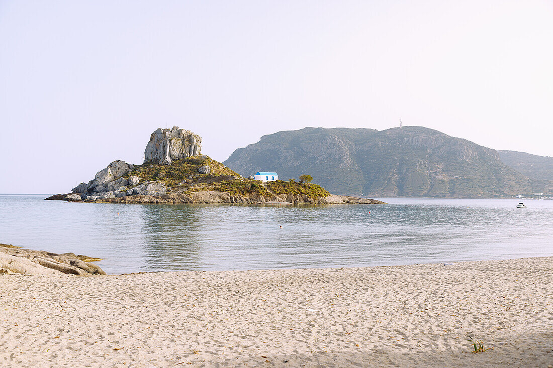  View of the island of Kastri with the chapel of Agios Nikolaos in the bay of Kefalos on the island of Kos in Greece 