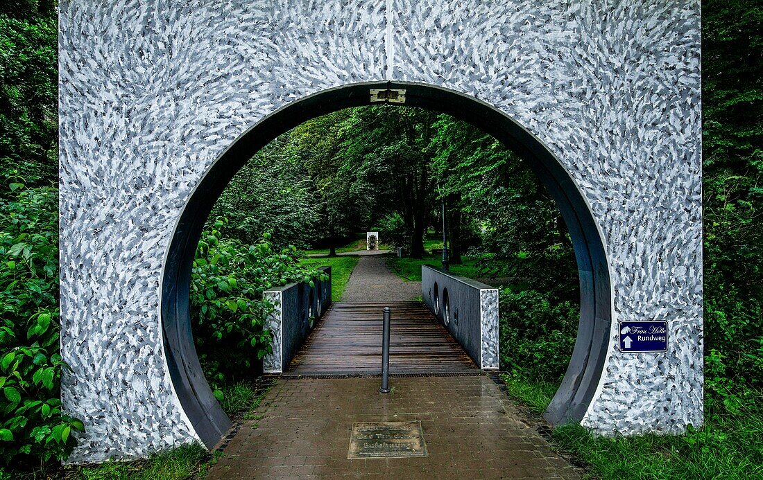  Gate to the Frau-Holle-Park, Frau Holle circular path, in the background the statue for Frau Holle, Hessisch Lichtenau, Hesse, Germany 