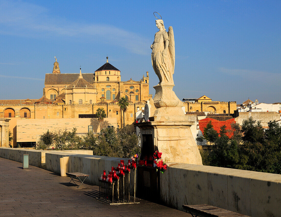 Angel San Rafael statue on Roman bridge with views cathedral, Cordoba, Spain