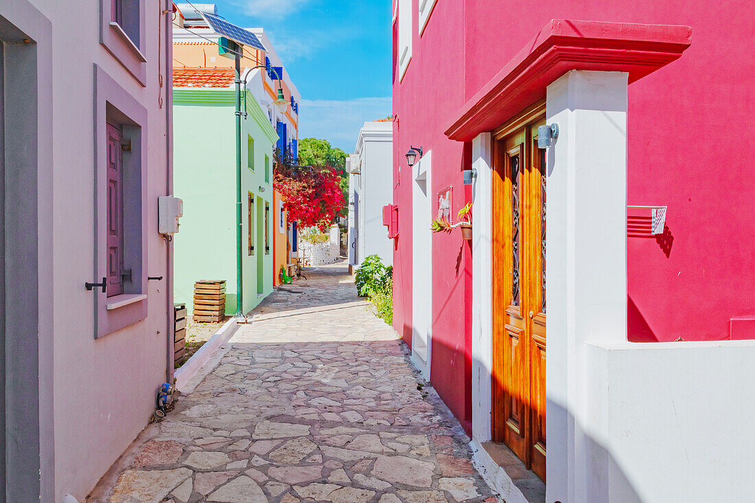 Emporio town street filled with Halki traditional houses, Halki Island, Dodecanese Islands, Greece