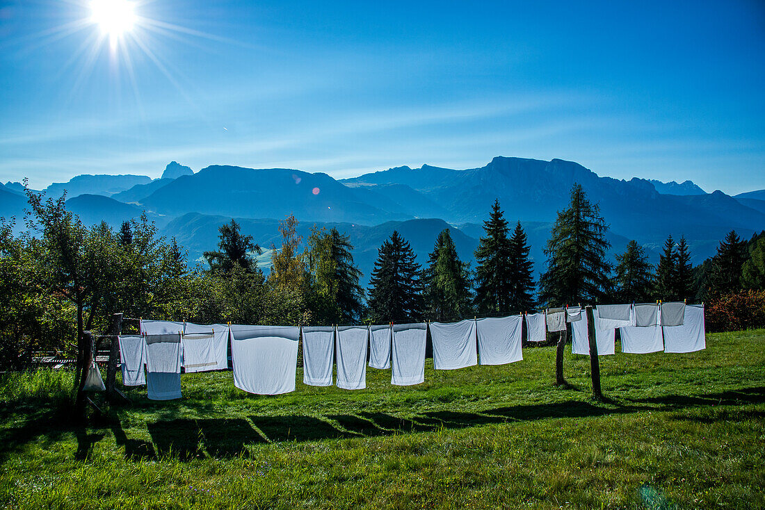 Waschtag, Wäsche auf der Leine und Ausblick auf die Berglandschaft bis zu den Dolomiten, Eisacktal, Südtirol, Trentino, Italien