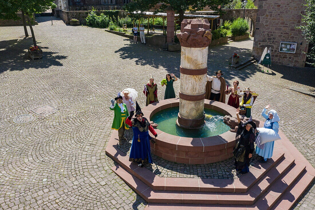  Aerial view of the fairy tale characters of the Brothers Grimm standing around the fairy tale fountain in the old town, Steinau an der Straße, Spessart-Mainland, Hesse, Germany 