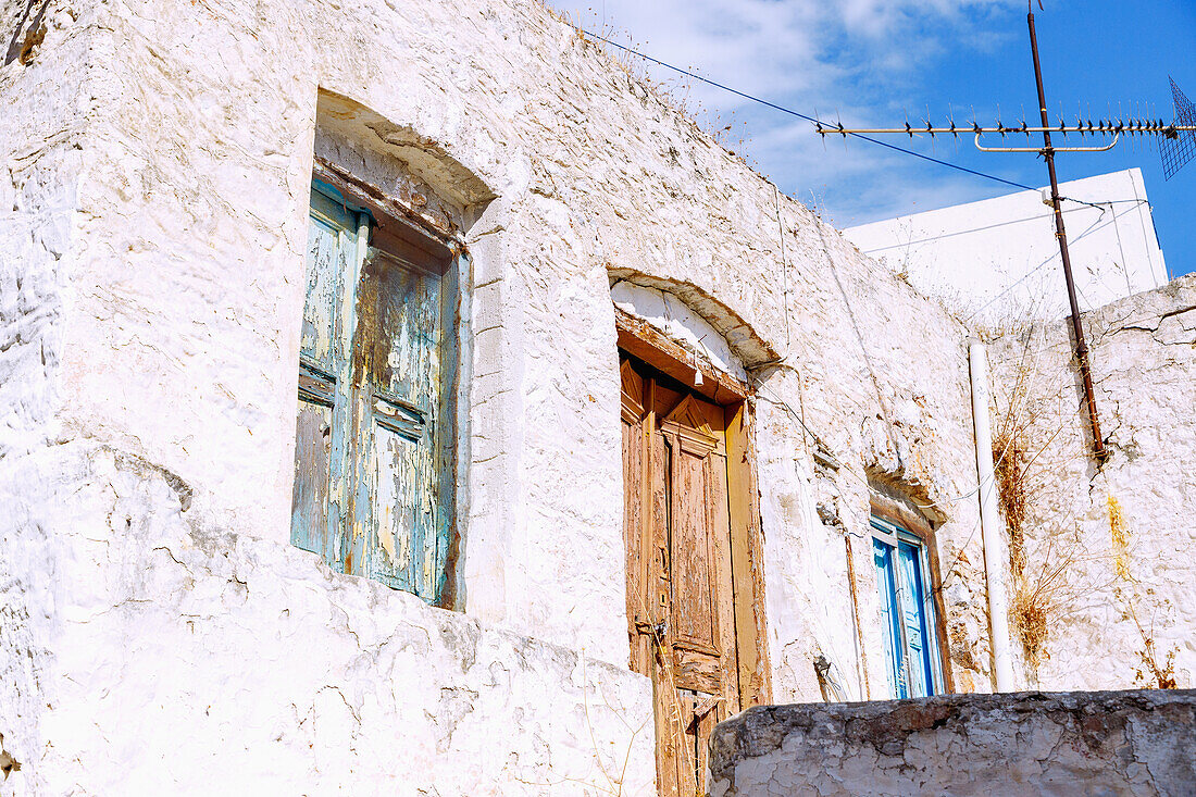  abandoned house with different colored doors and shutters in the old town in Chorió on the island of Kalymnos (Kalimnos) in Greece 