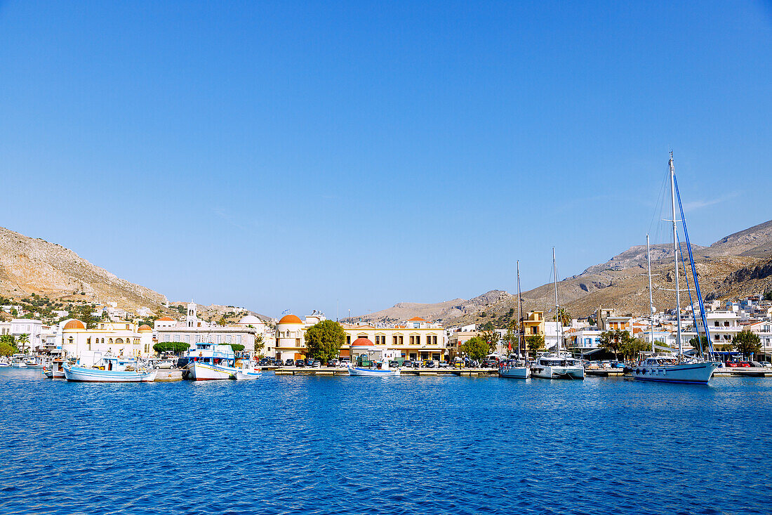  View of the island capital Póthia with customs and port office, nautical museum, town hall (Dimarchio) fishing boats at the harbor on the island of Kalymnos (Kalimnos) in Greece 