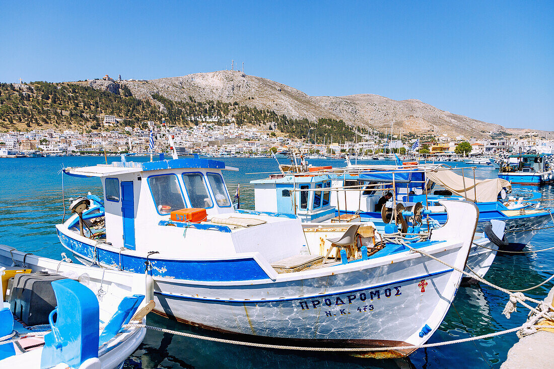  Island capital Póthia, fishing boats in the harbor and monastery Agíou Savvas on the hill above Pothia on the island of Kalymnos (Kalimnos) in Greece 