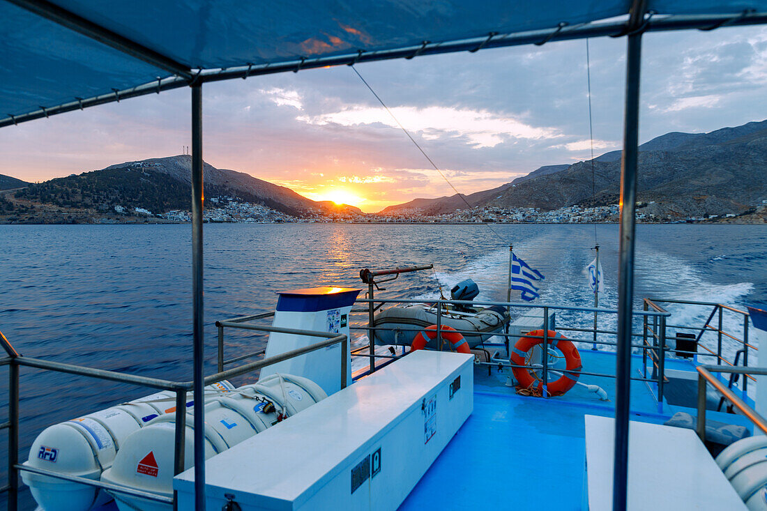  View of the sunset behind Póthia on the island of Kalymnos (Kalimnos) in Greece from the ferry to the island of Kos 