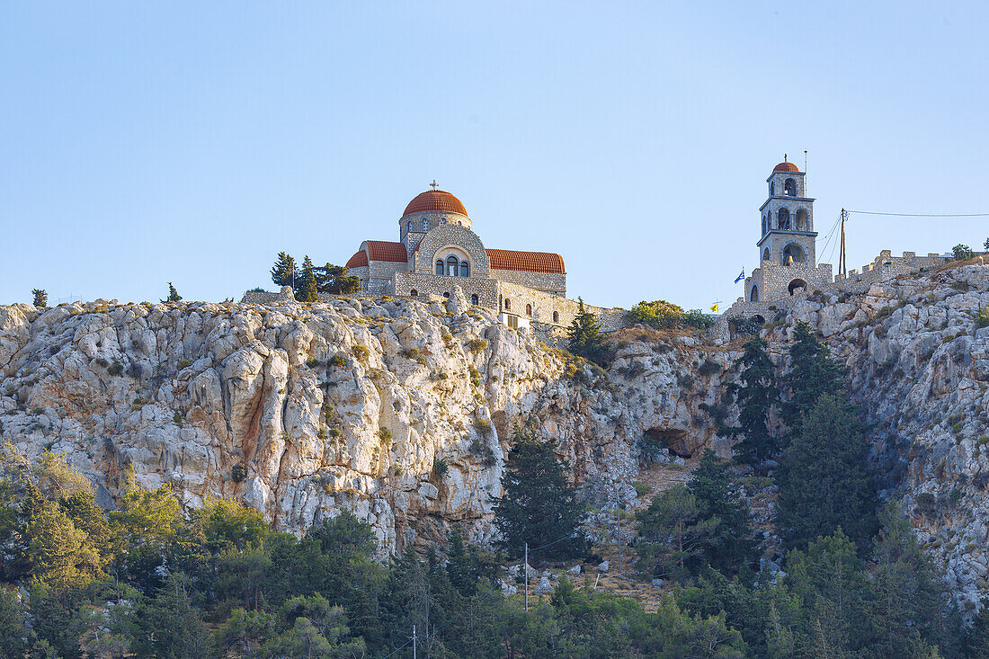  Monastery of Moni Agíou Savvas with bell tower on the rocks above the village of Póthia on the island of Kalymnos (Kalimnos) in Greece 