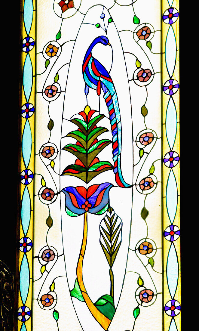  Stained glass window with peacock and flowers in the interior of the church Àgion Pándon in the monastery Moni Agíou Savvas near Póthia on the island of Kalymnos (Kalimnos) in Greece 