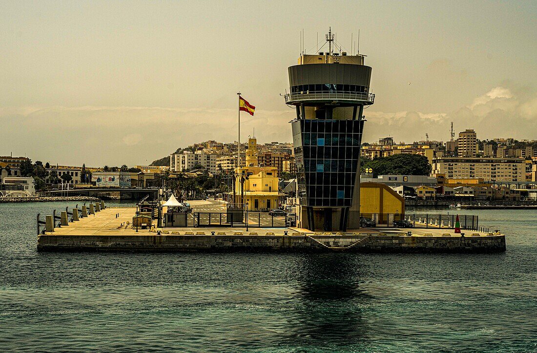  Port of Ceuta with port tower and Spanish flag, in the background the city center, Ceuta, North African coast, Spain 