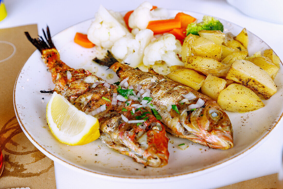 gegrillter frischer Fisch (Red Snapper) mit Gemüse und Bratkartoffeln in der Taverne Agios Theologos auf der Halbinsel Kefalos auf der Insel Kos in Griechenland