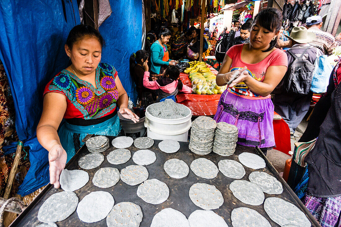 Manual toasting of typical pancakes, Chichicastenango, municipality of the department of El Quiché, Guatemala, Central America