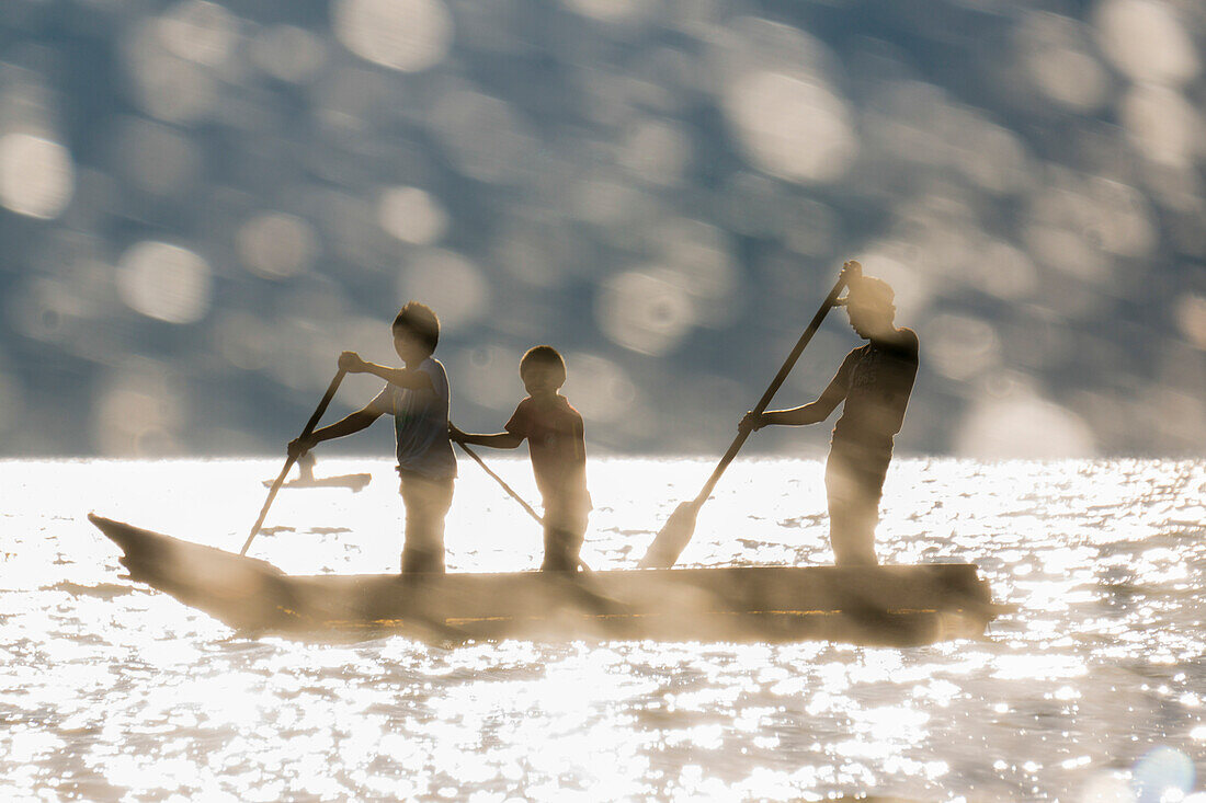 Tourists on a mooring enjoying the sunset, Lake Atitlan and San Pedro volcano, Santiago Atitlan, Sololá department, Guatemala, Central America