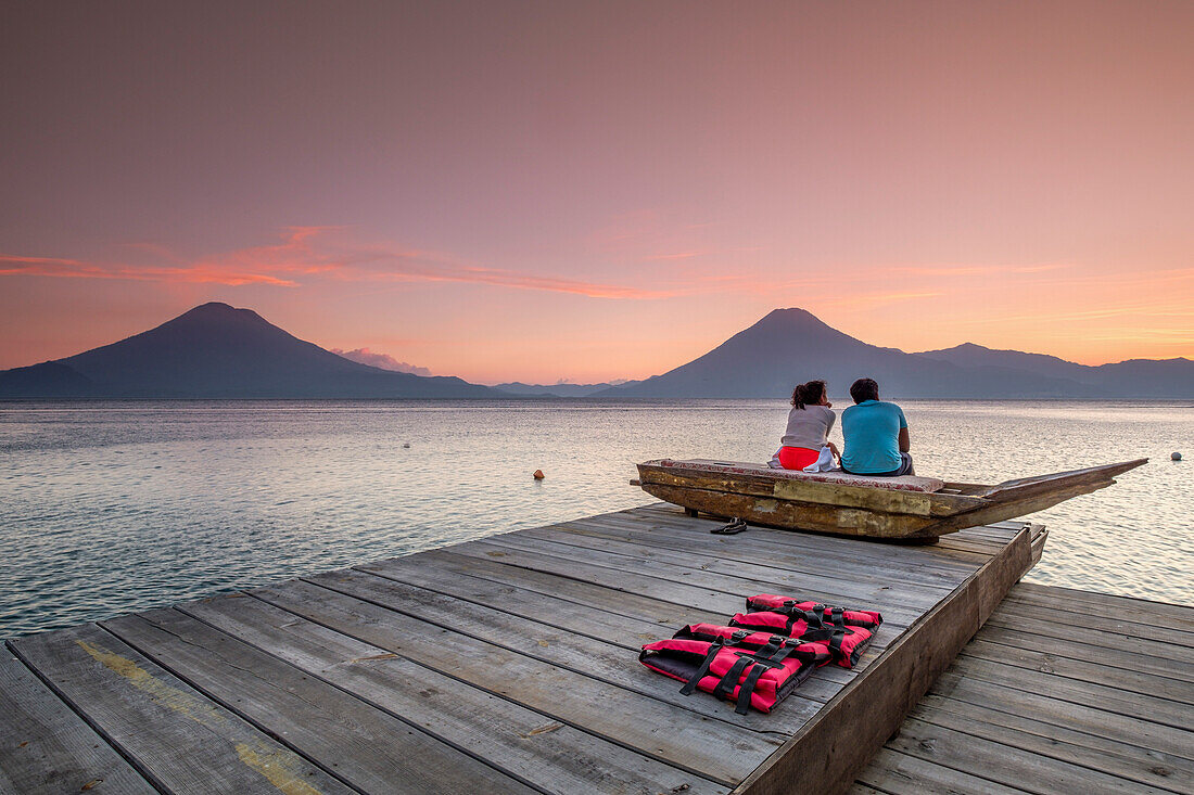  Touristen an einer Anlegestelle genießen den Sonnenuntergang, Atitlan-See und Vulkan San Pedro, Santiago Atitlan, Departement Sololá, Guatemala, Mittelamerika 