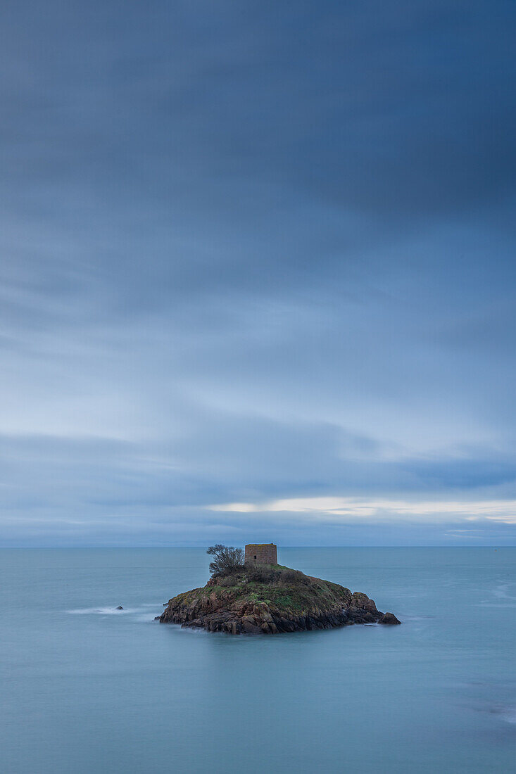  Tower on the small island of Ile au Guerdain. Blue cloudy sky, calm sea. 