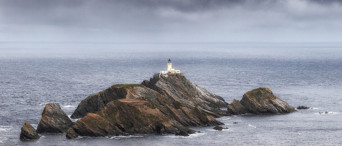  Rocky islands in the sea with the lonely lighthouse Muckla Flugga. 