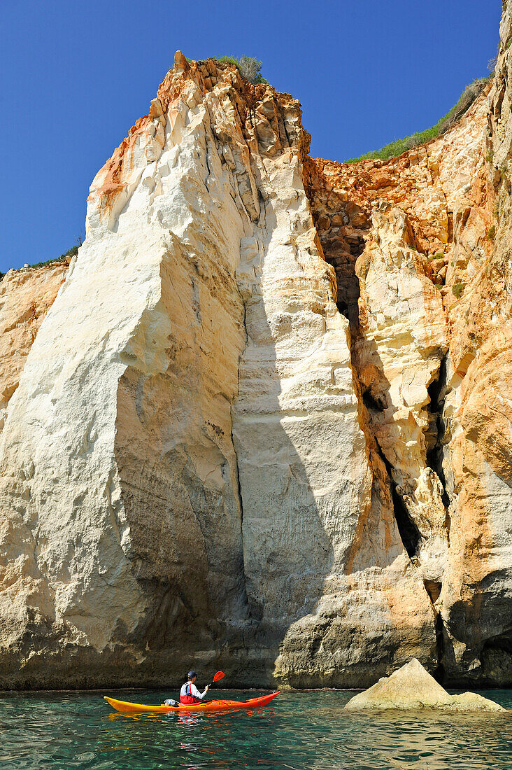 kayak at the entrance of a cave inside the cliff near Cala Galdana, South Coast of Cala Galdana, Menorca, Balearic Islands, Spain, Europe