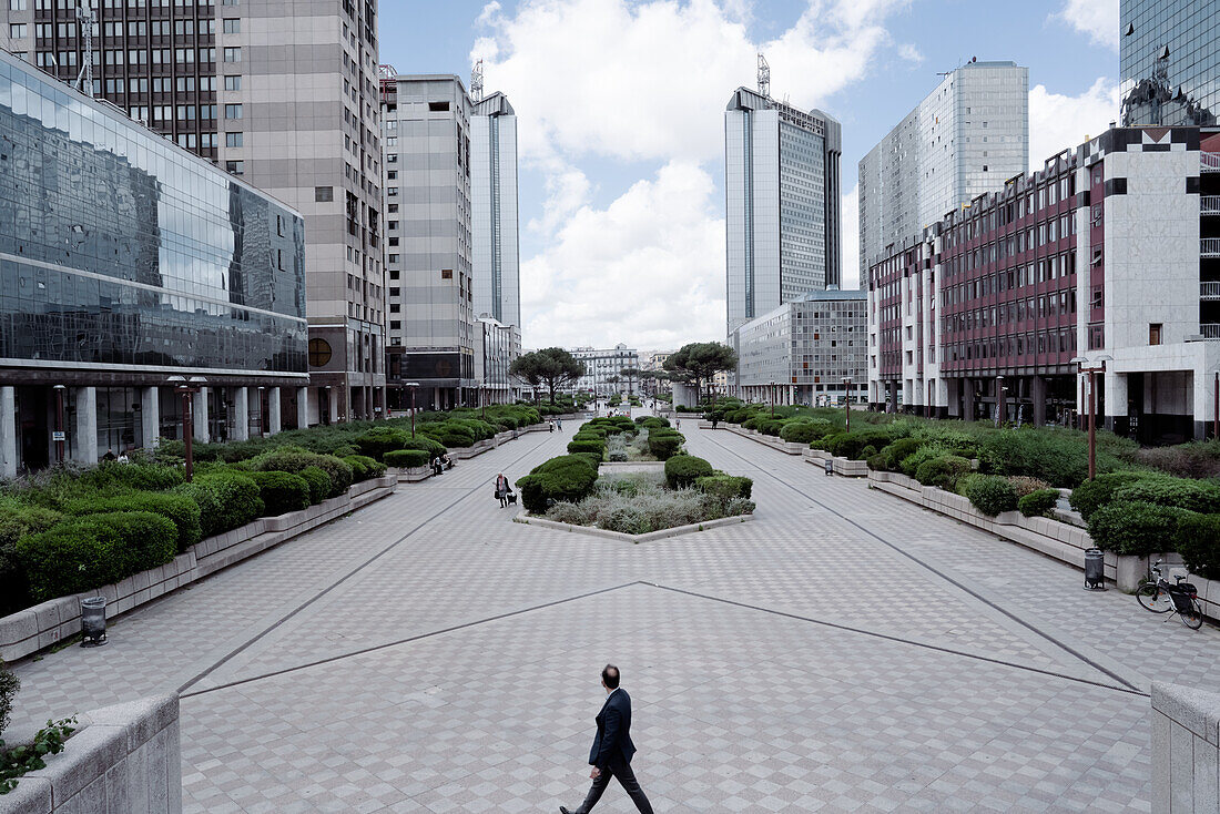 Man standing at the center of a skyline view from a typical directional center.