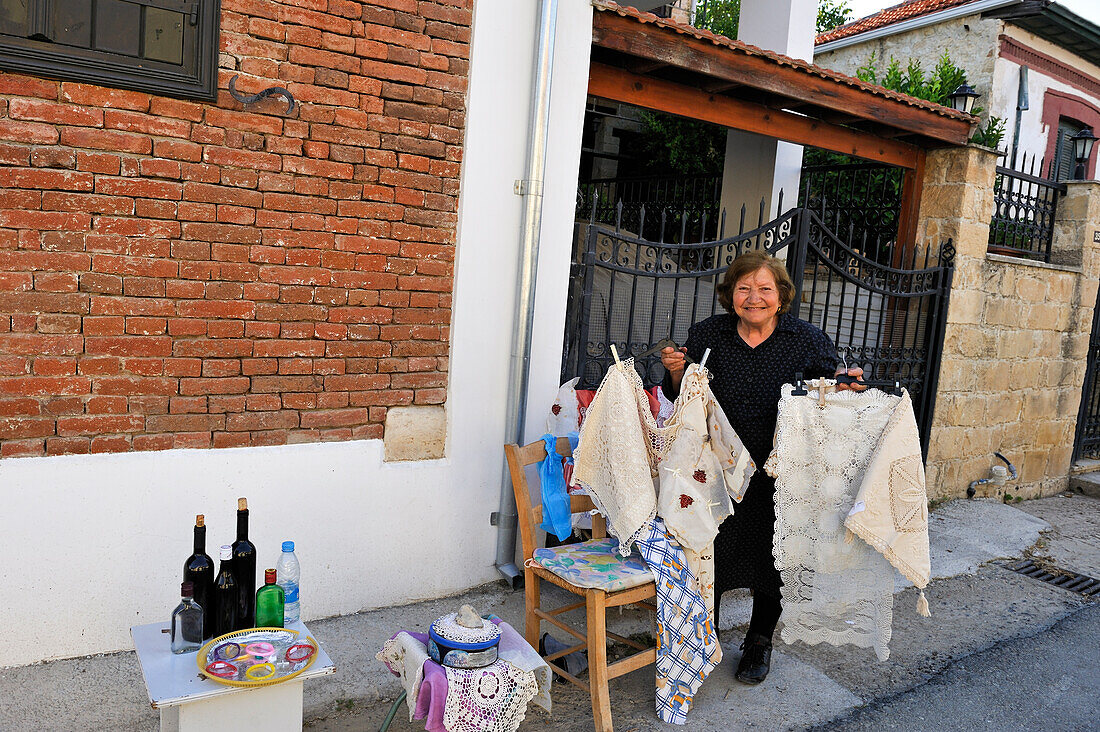 woman selling crafts in front of her home,Omodos, village in Troodos Mountains,Cyprus,Eastern Mediterranean Sea