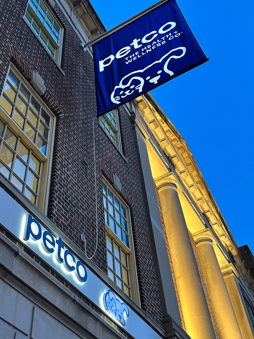 Petco store, building exterior, low angle view at dusk, New York City, New York, USA