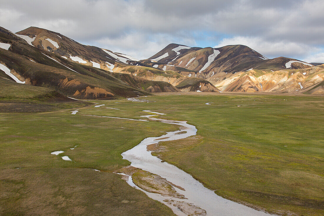  Colourful rhyolite mountains with snow remnants at Brennisteinsalda volcano in Landmannalaugar, Fjallabak National Park, Sudurland, Iceland 