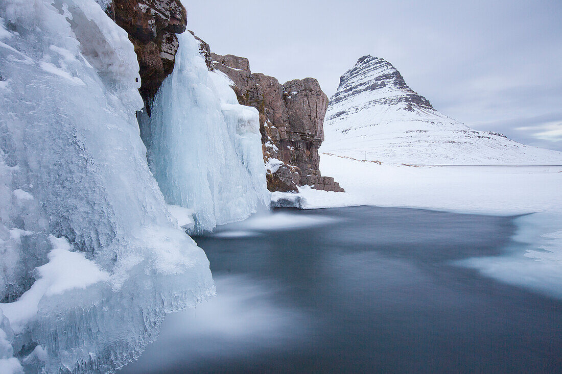  Kirkjufjell mountain with Kirkjufjellsfoss waterfall, winter, Iceland 