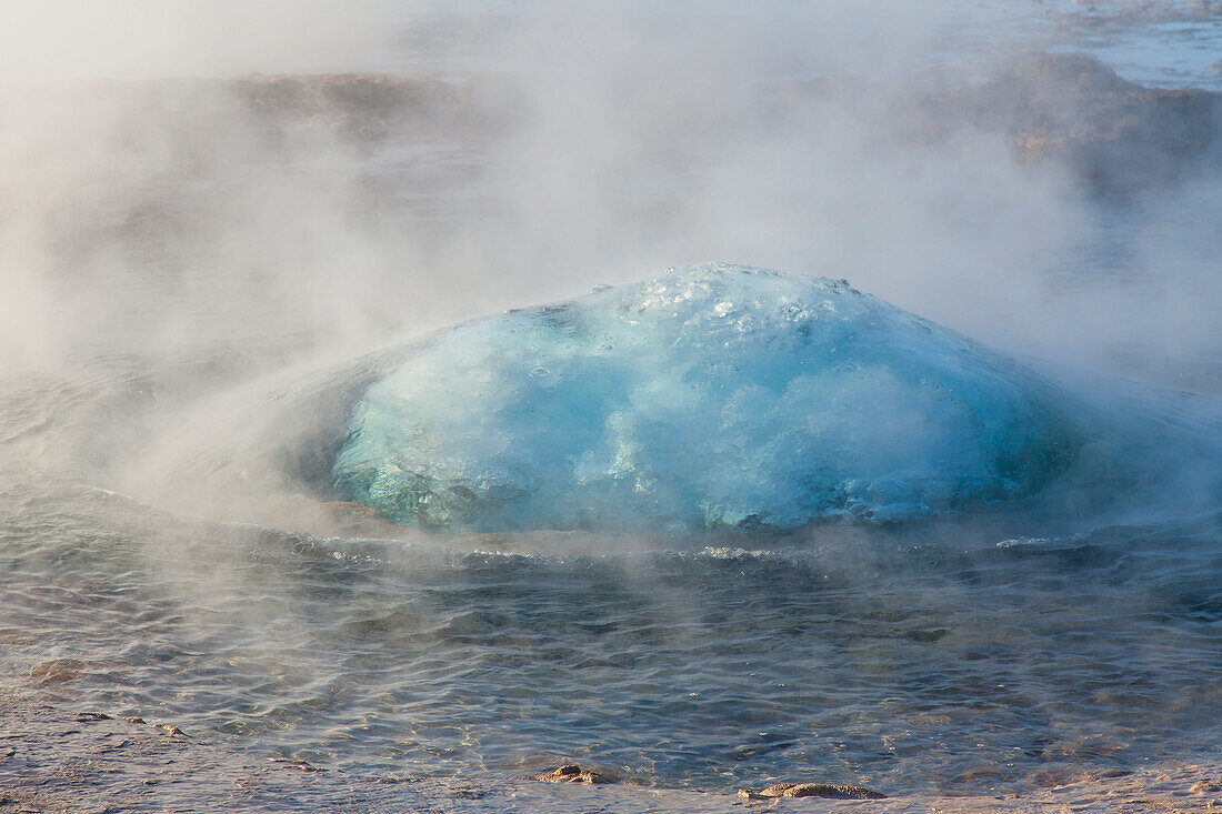  Strokkur Geysir (Butter Churn Geysir) in the Haukadalur hot water valley shortly before eruption, winter, Iceland 