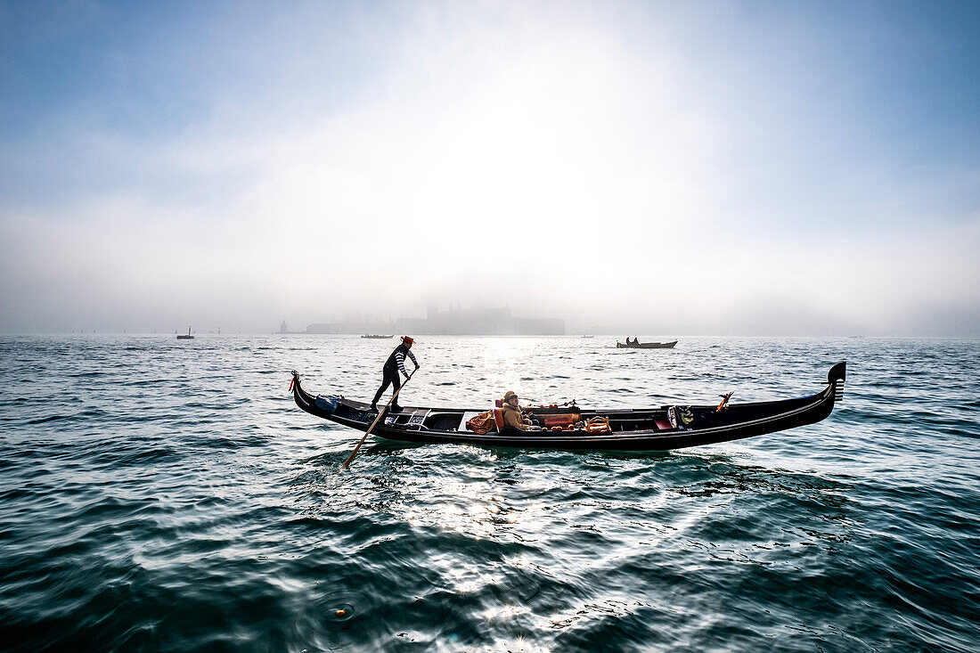  Gondolier in the fog overlooking the Giudecca, Venice, Veneto, Italy 