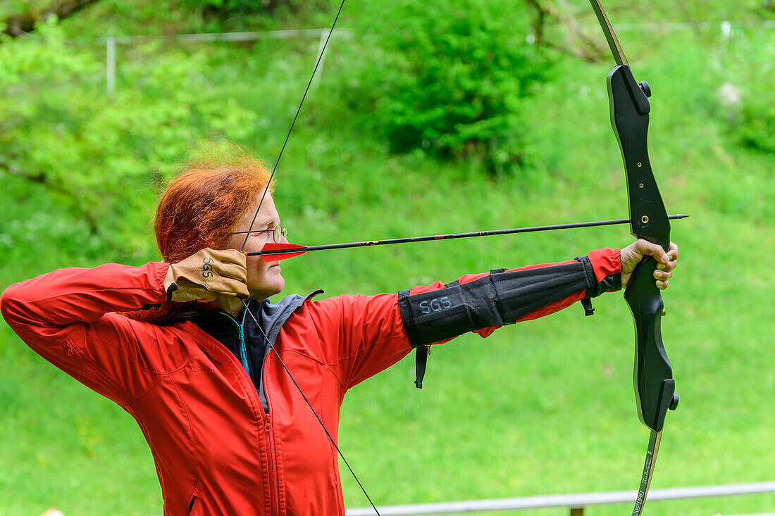 Frau beim Bogenschießen, Millstätter See, Nockberge, Niedere Tauern, Kärnten, Österreich