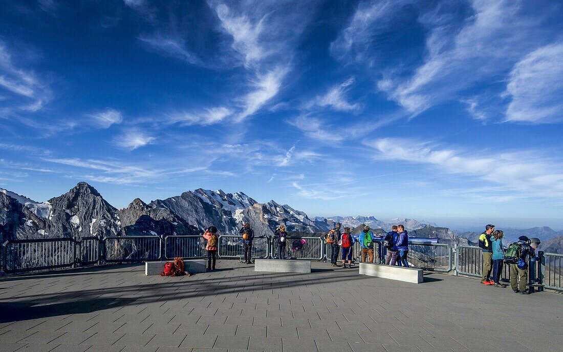  Tourists on the terrace of the panoramic restaurant &quot;Piz Gloria&quot; on the Schilthorn, view of the Alpine mountains, Mürren, Bernese Oberland, Switzerland 