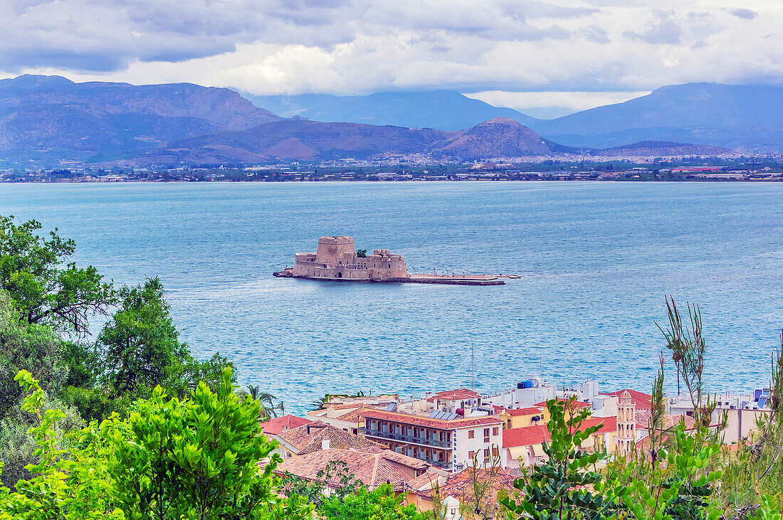  View of houses of the city of Nafplio with the fortress of Bourtzi in the background, Peloponnese, Greece 