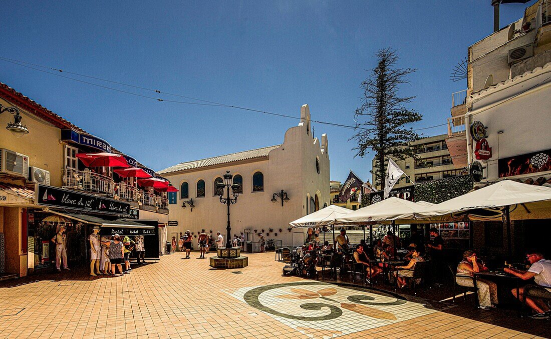  Street restaurant and shops in the old town of Torremolinos, San Miguel church in the background, Costa del Sol, Spain 