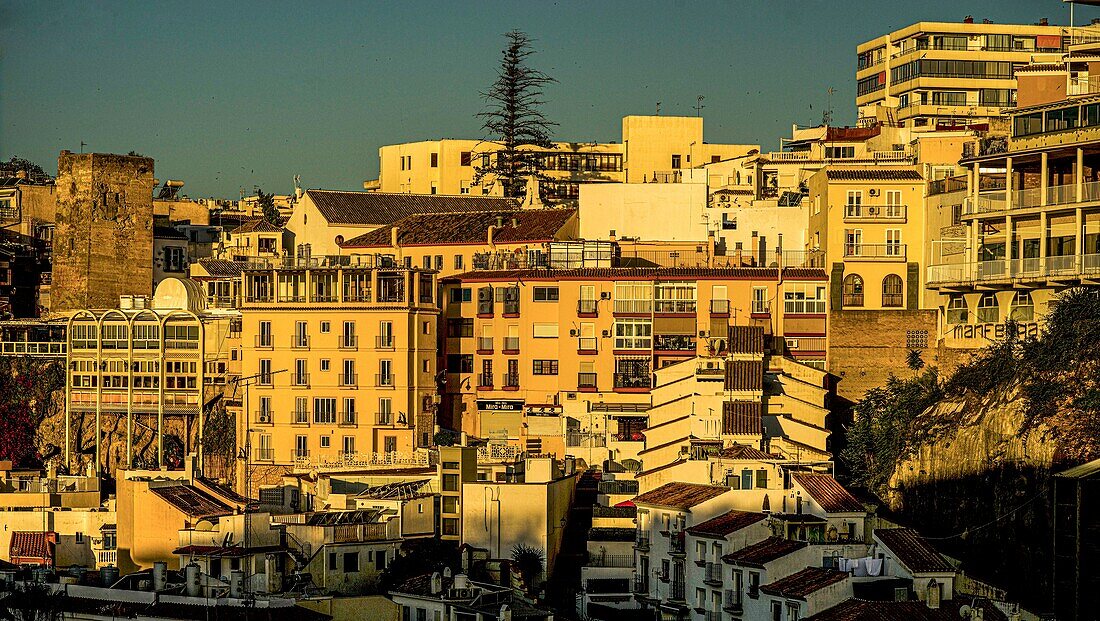  The Torre de Pimentel (1300) and the modern hotel and apartment complex in the city centre of Torremolinos in the morning light, seen from the Apartamentos Bajondillo, Costa del Sol, Spain 