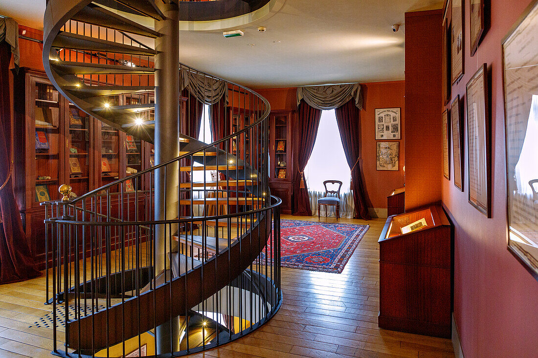  Living room and spiral staircase in the Maison Jules Verne (Maison à la Tour, house of Jules Verne) in Amiens in the Somme department in the Hauts-de-France region of France 