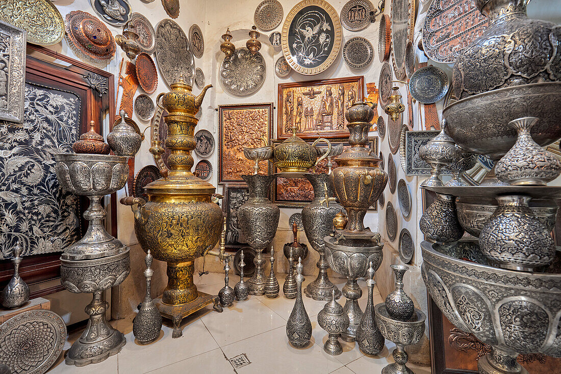 A selection of Qalamzani, or Ghalamzani (traditional Iranian metal engraving art) items displayed in a gift shop in the Grand Bazaar. Isfahan, Iran.