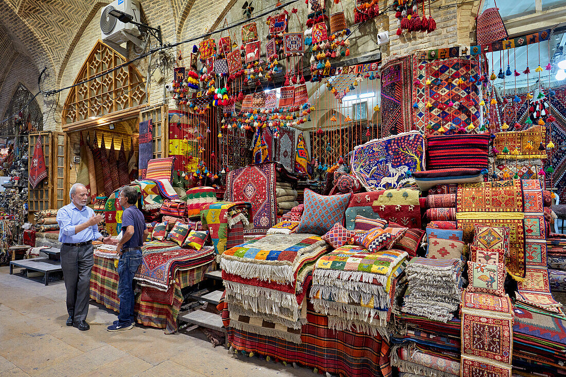  Zwei iranische Männer unterhalten sich in einem Kunsthandwerksladen im Vakil-Basar. Shiraz, Iran. 